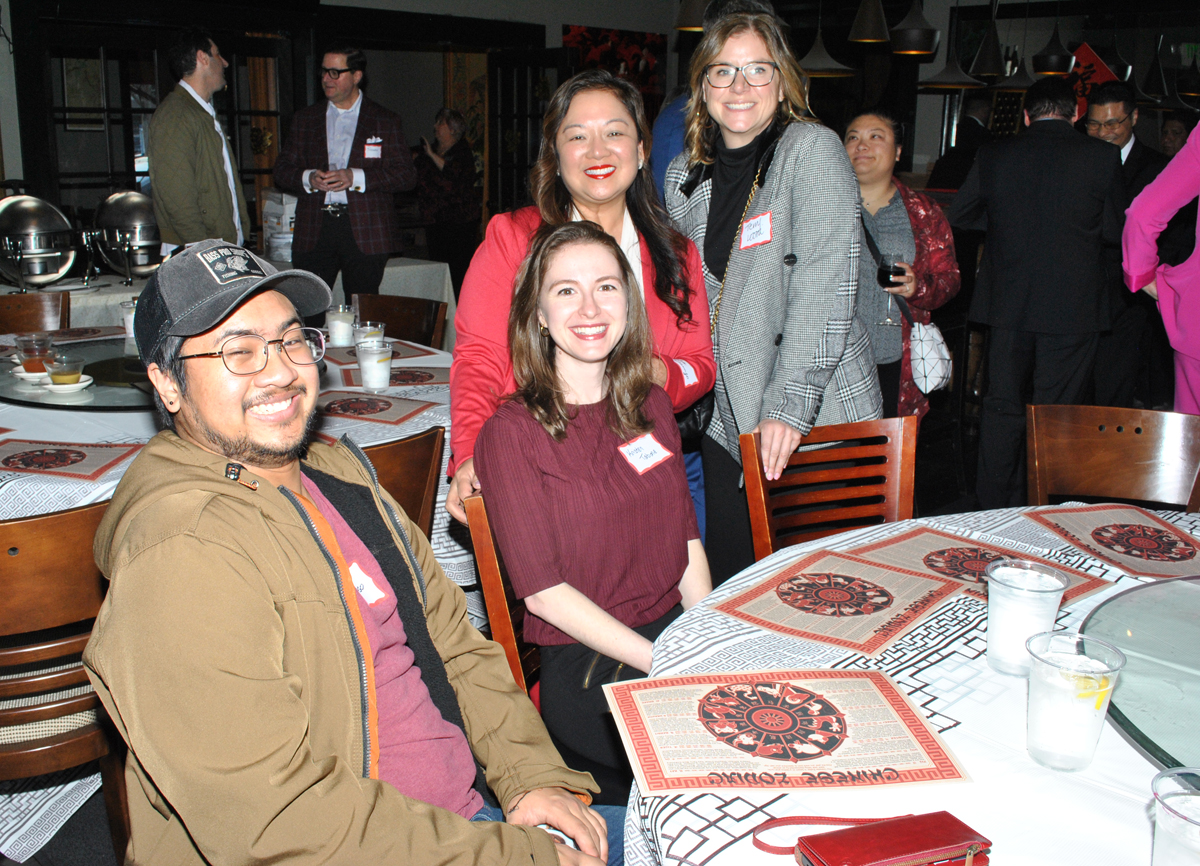 A group of people around a table at Lunar New Year celebration.