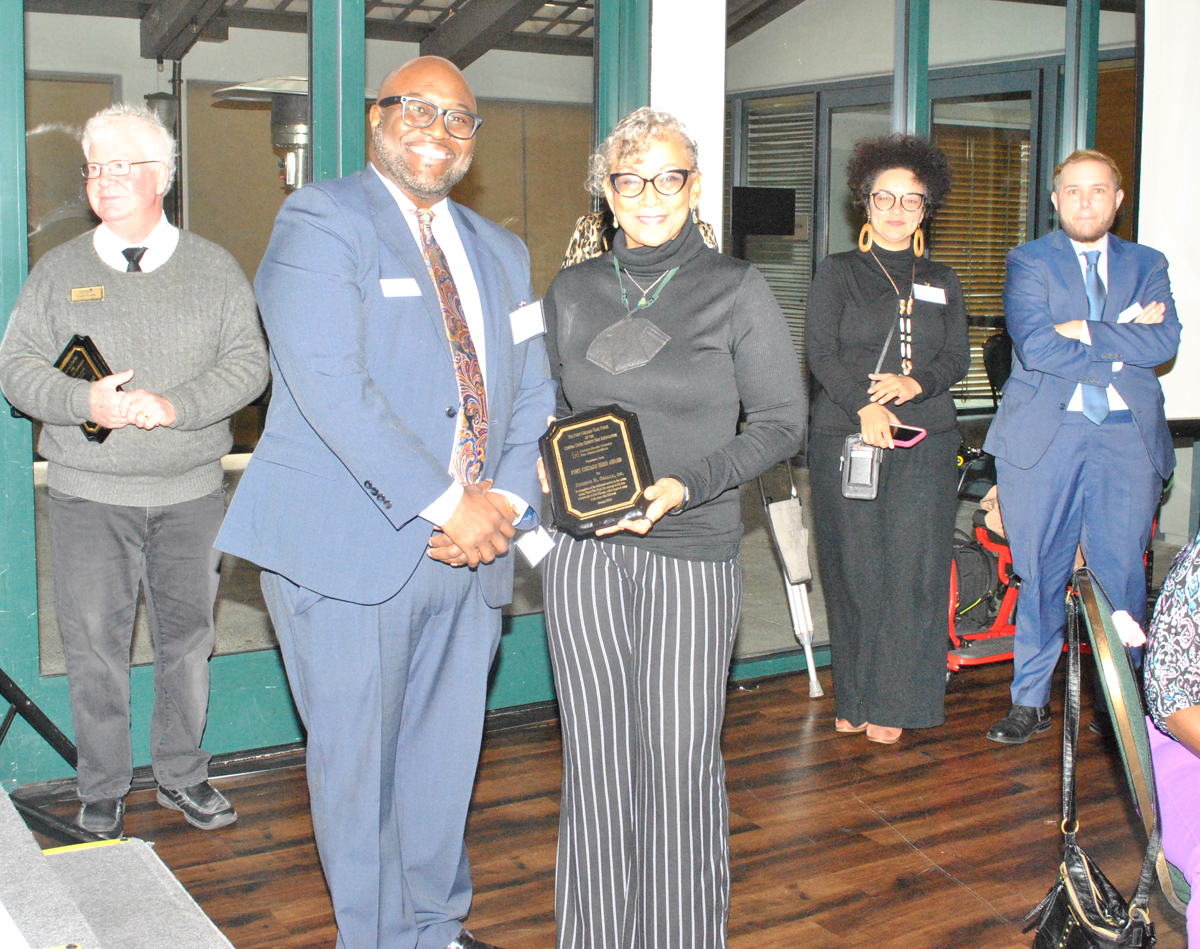 Man presents award to woman at CCCBA Awards luncheon