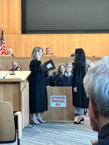 A judge raises her right hand and takes the oath of judicial office.