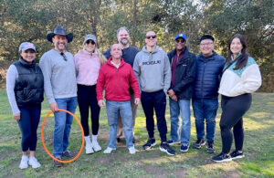 A group of people gather outdoors in a park