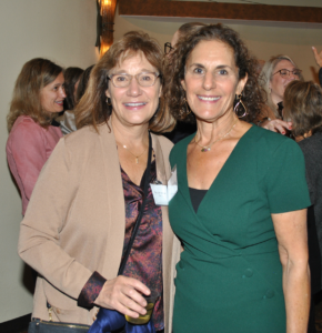 Two women standing together, smiling