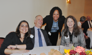 A group of smiling people at a table.